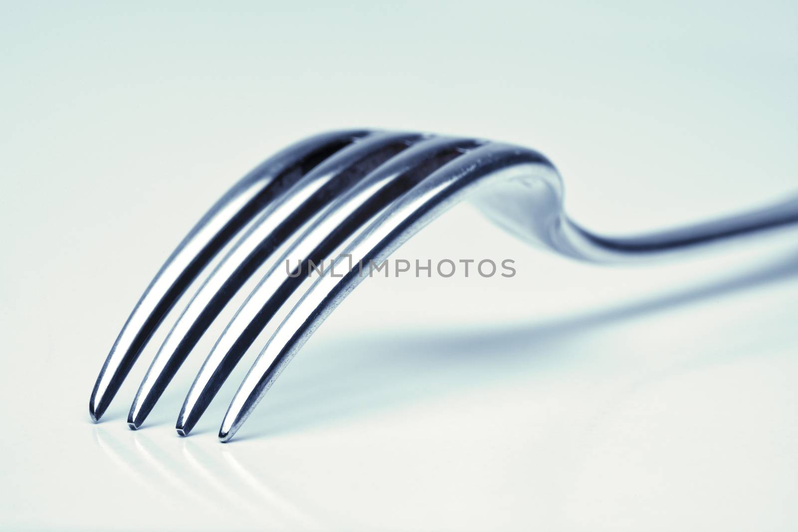 silverware - extreme closeup of a fork with blue tint