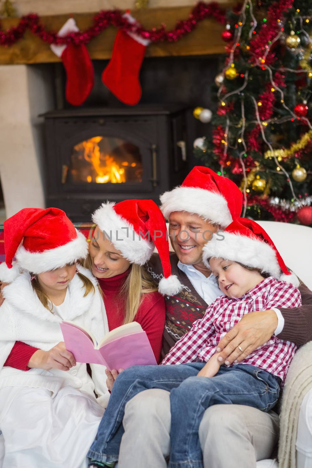 Happy family reading at christmas at home in the living room