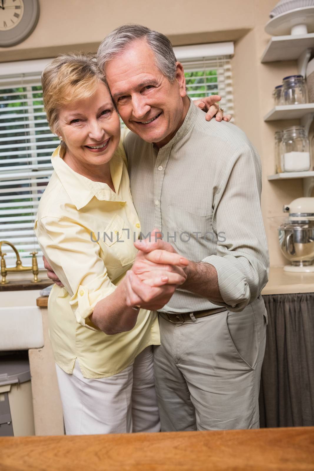Romantic senior couple dancing together  by Wavebreakmedia