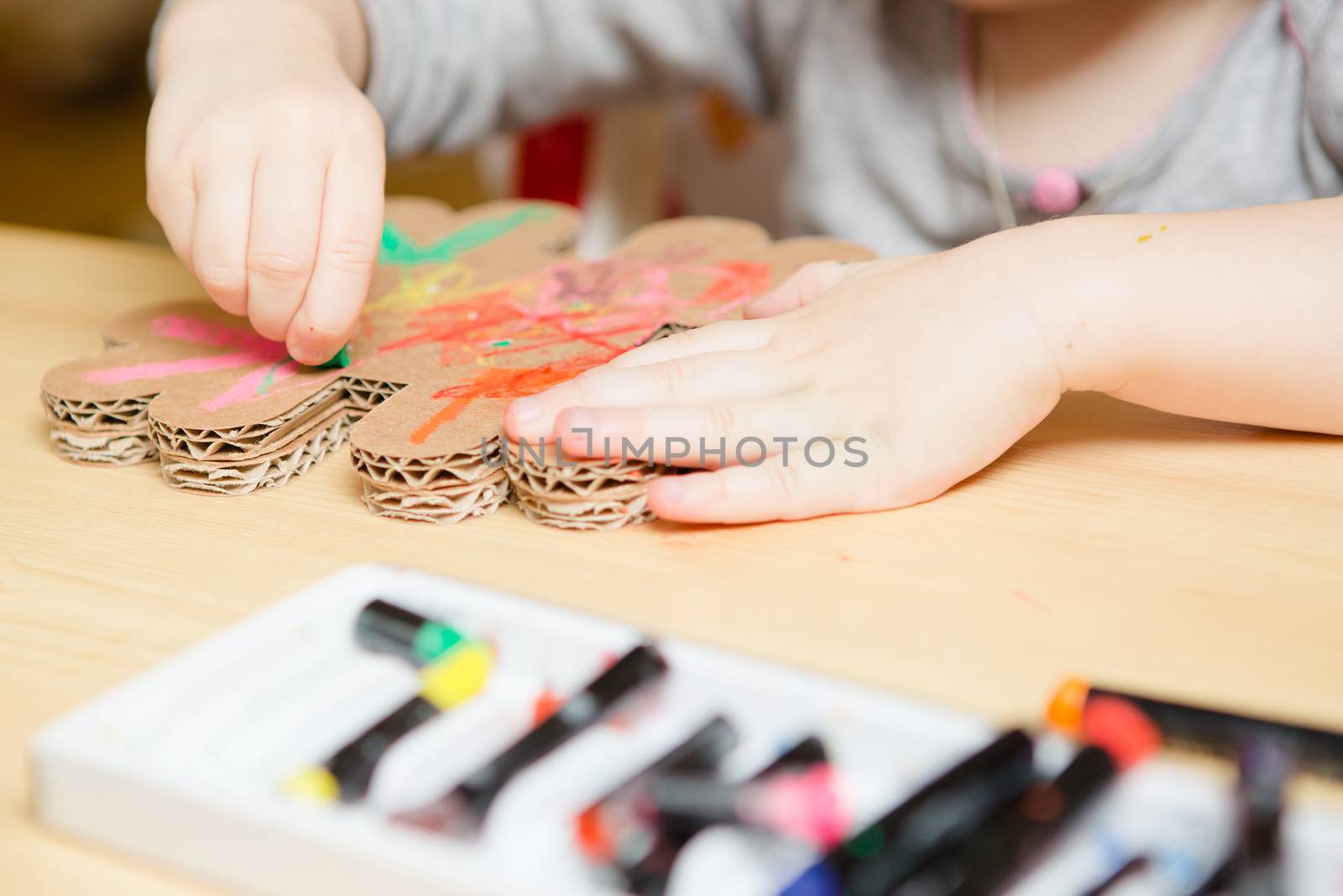 Little female baby painting with colorful paints by sarymsakov