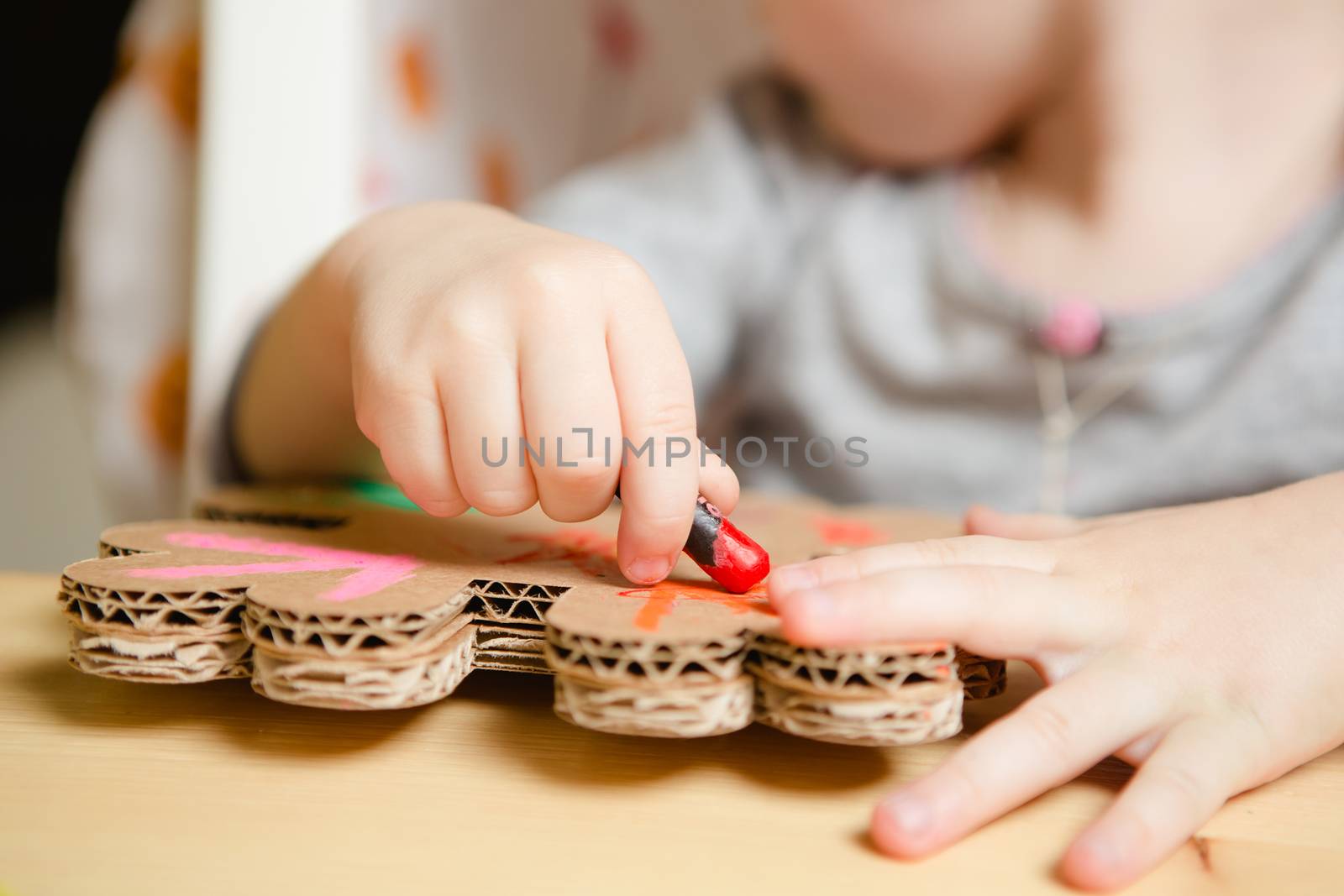 Little female baby painting with colorful paints. selective focus