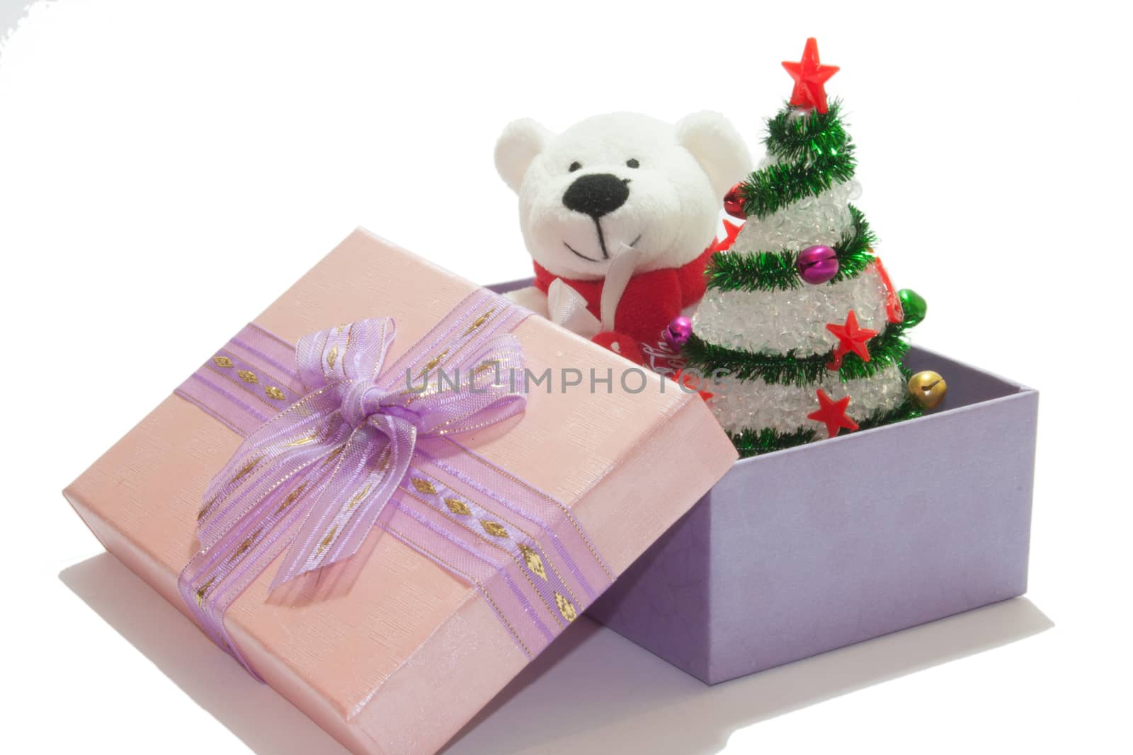 White teddy bear with christmas tree on the white background.
