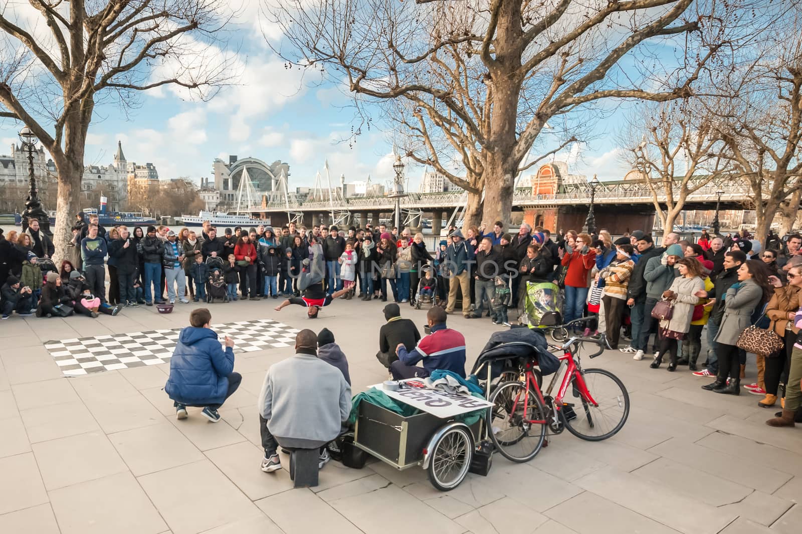 London, UK - January 27, 2013: A large crowd watching street dance performers on a cold afternoon by the South Bank of River Thames in London, UK