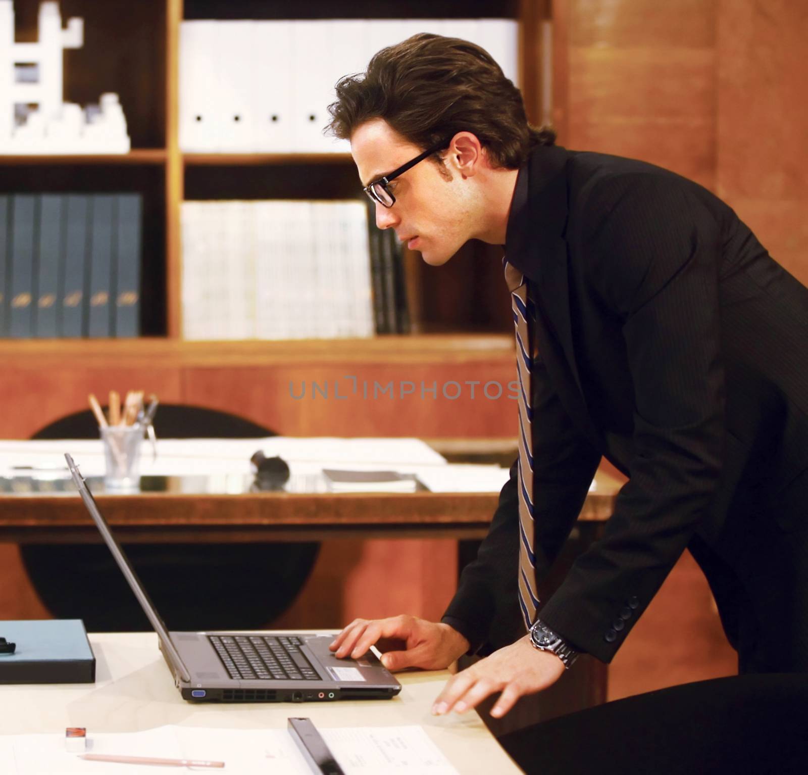 Portrait of businessman with laptop at modernoffice 