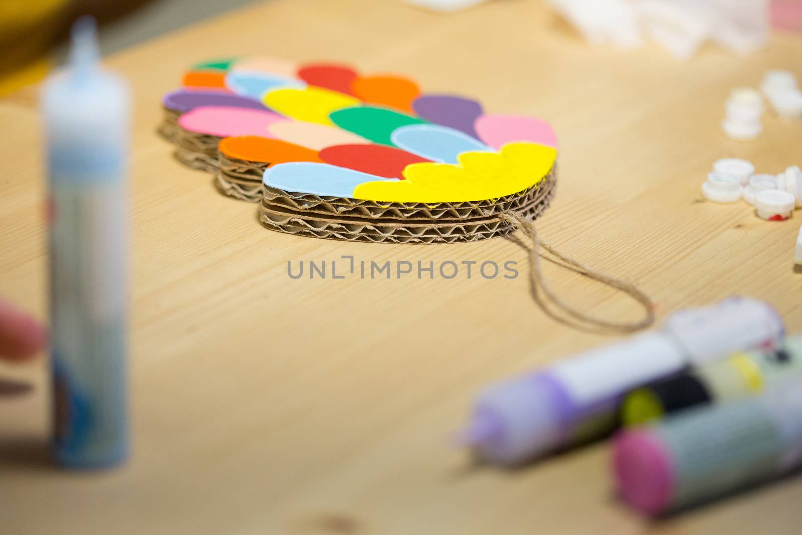 Colorful toys made of cardboard on a wooden table. Creative background