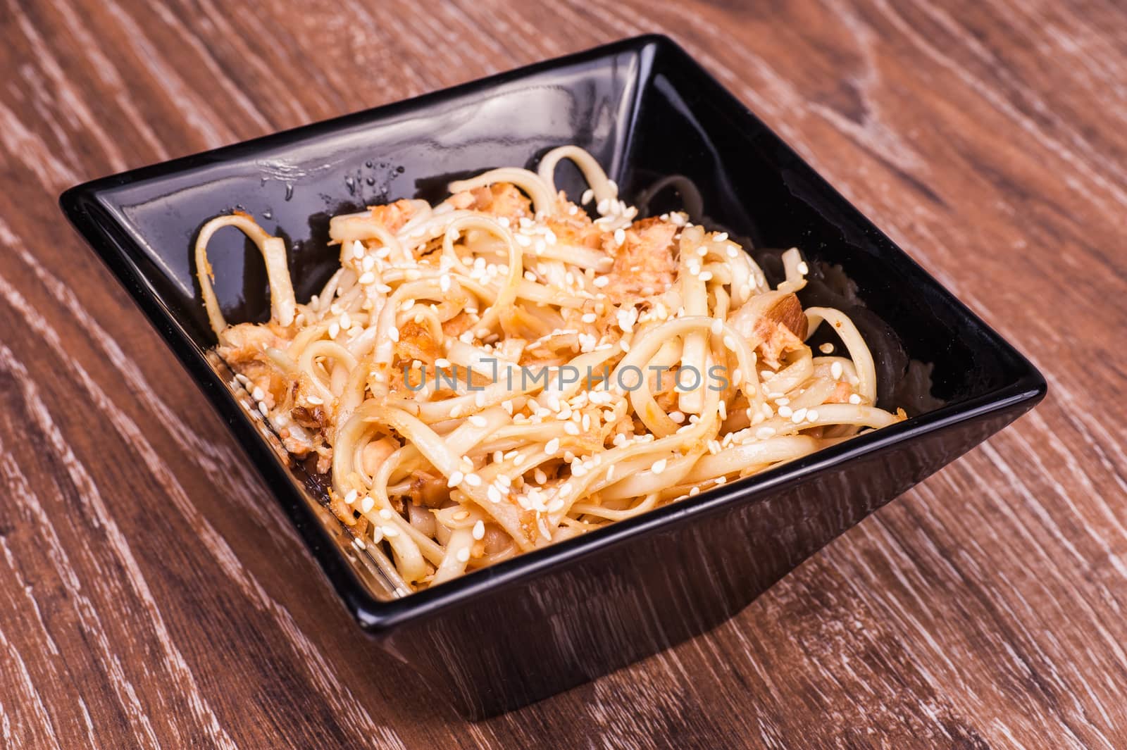 asian fried udon noodles on wooden background