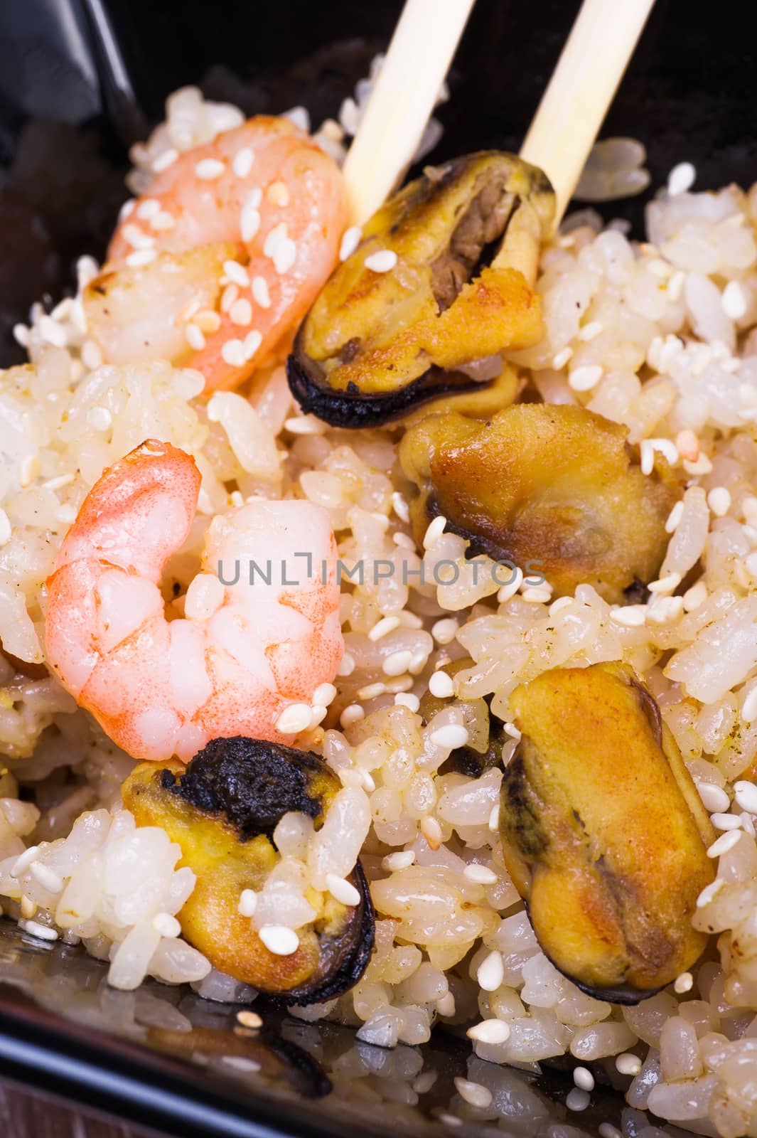 fried udon noodles with seafood on wooden background