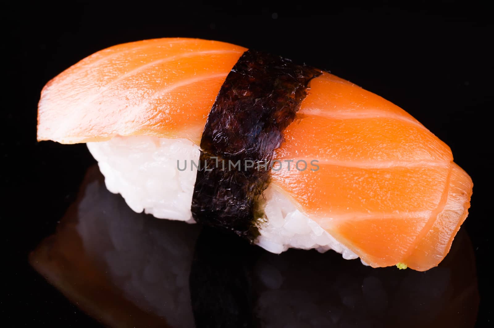 salmon sake nigiri isolated on black background