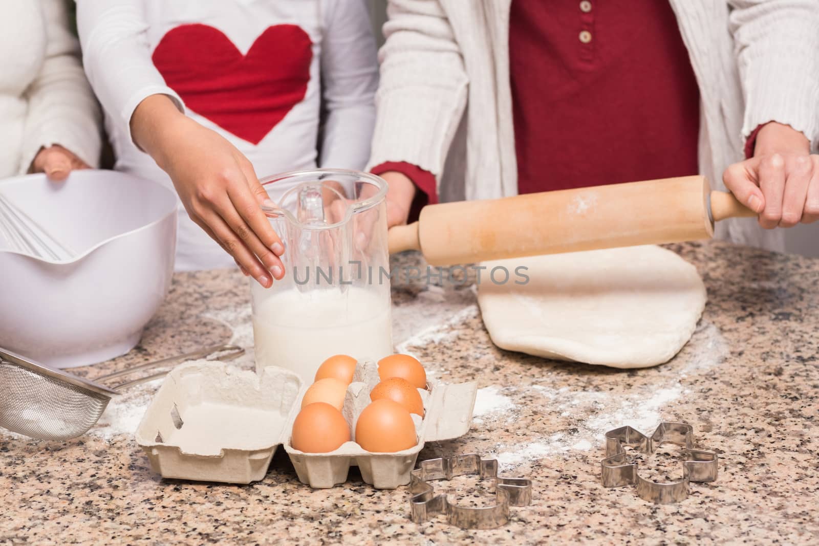 Multi-generation family baking together at home in the kitchen