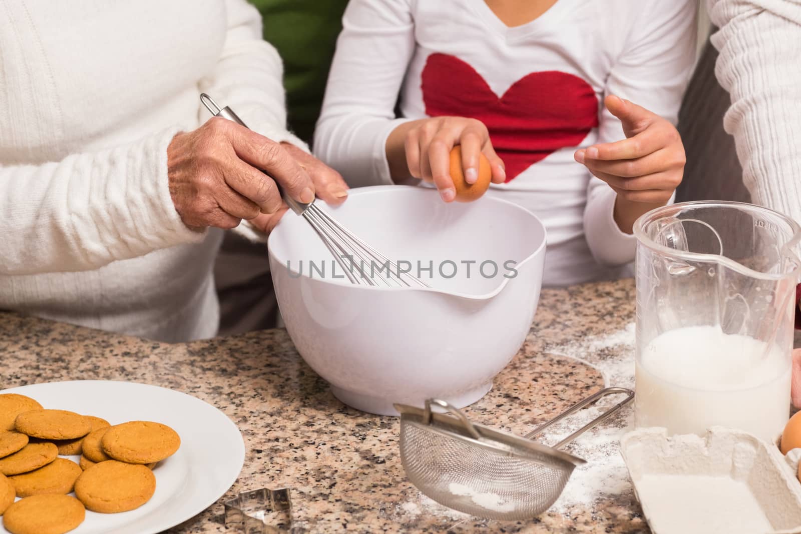 Multi-generation family baking together at home in the kitchen