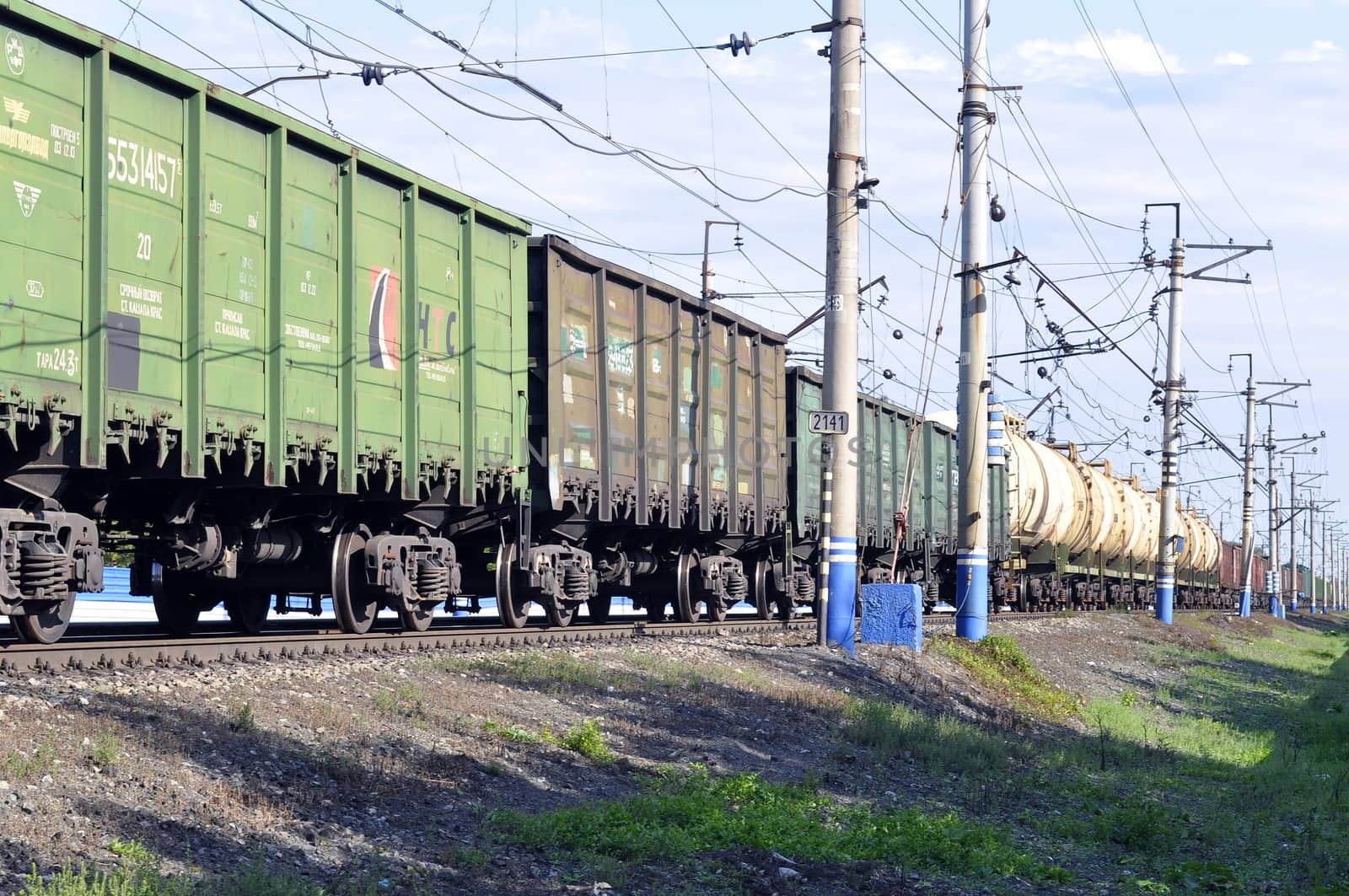 The cargo train on rails in the summer afternoon. by veronka72