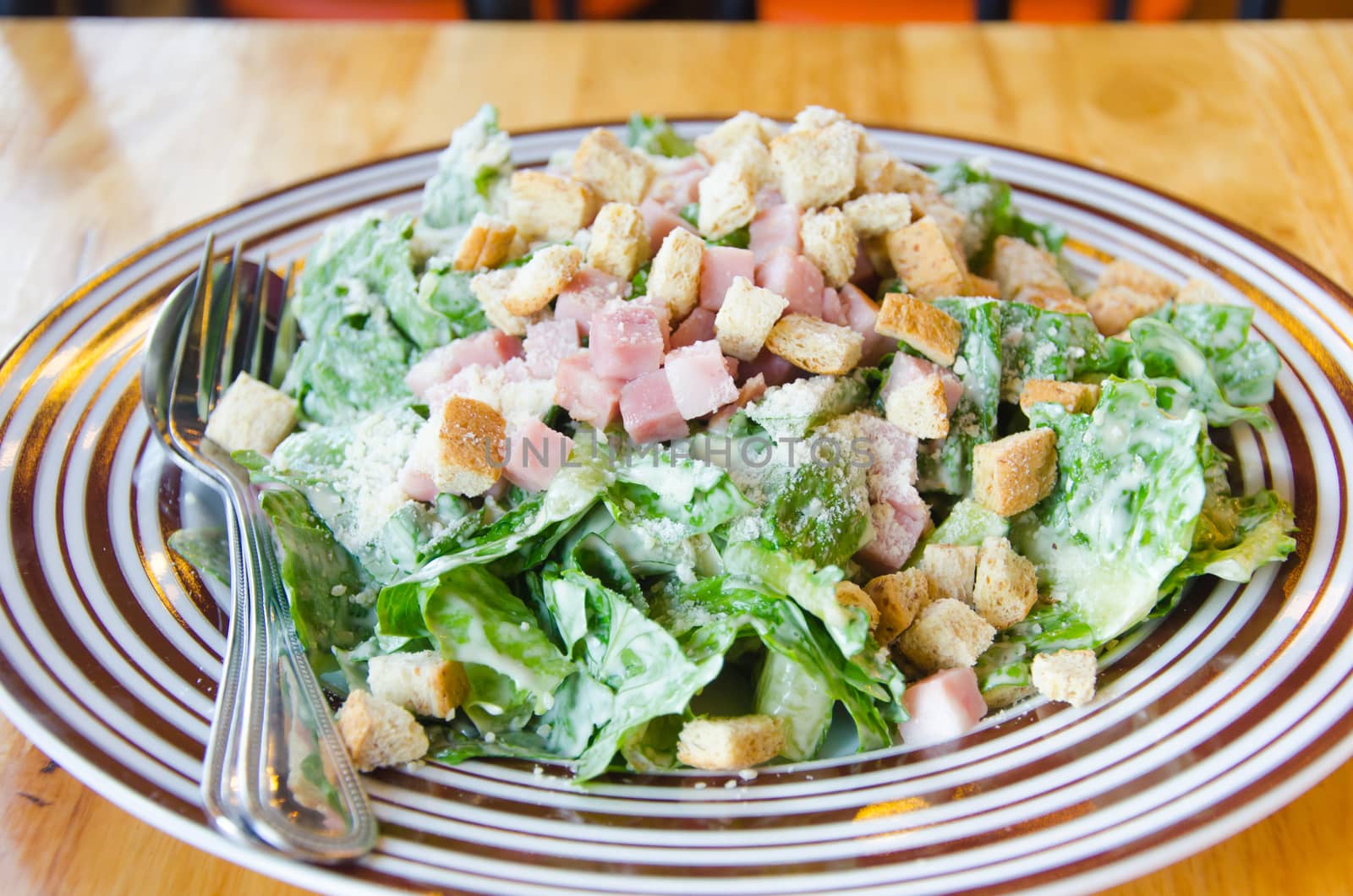 A Caesar salad is a salad of romaine lettuce and croutons dressed with parmesan cheese, lemon juice, olive oil,egg and etc.