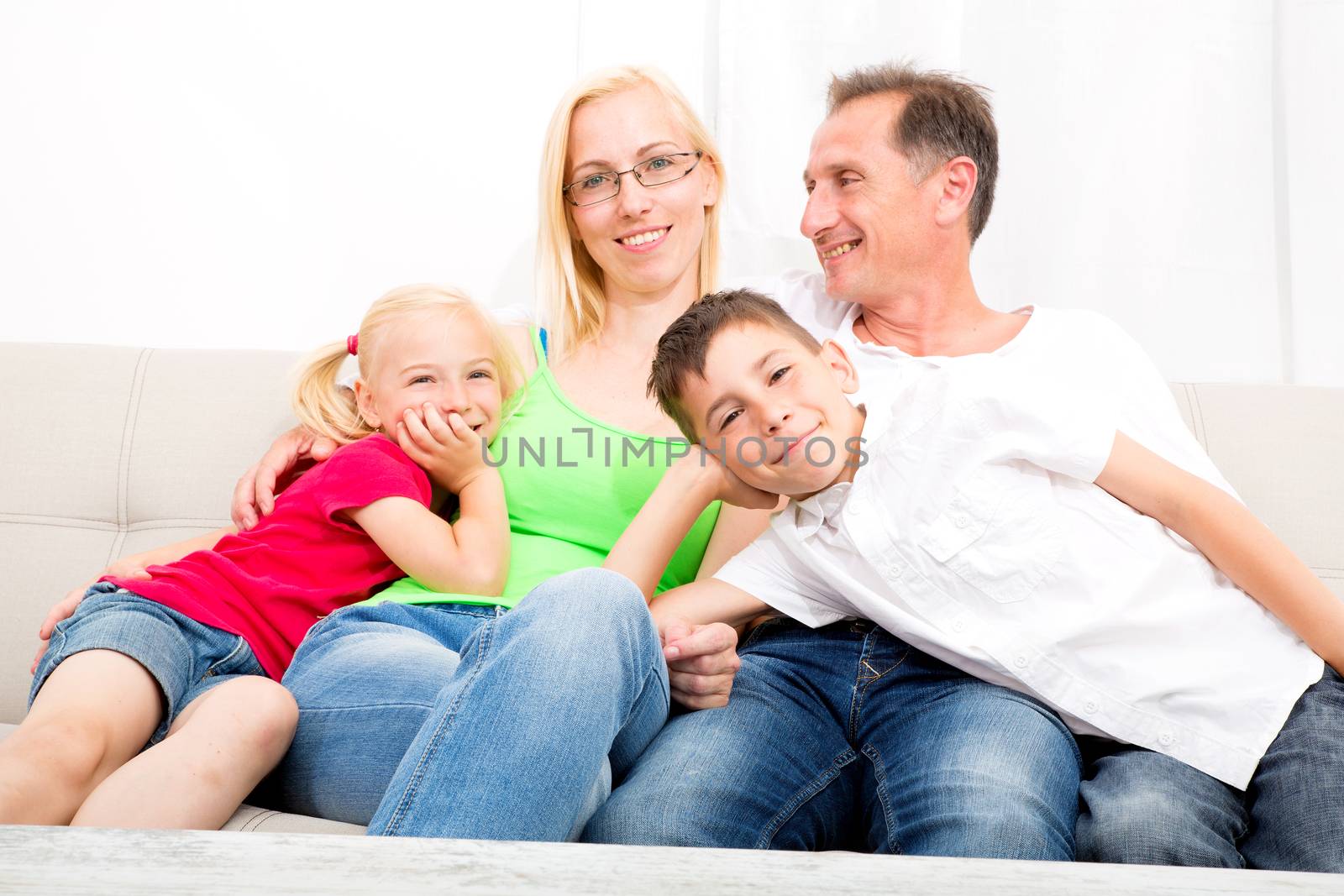 Happy family sitting together on the couch
