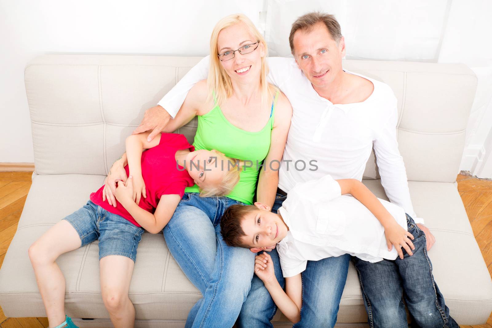 Happy family sitting together on the couch
