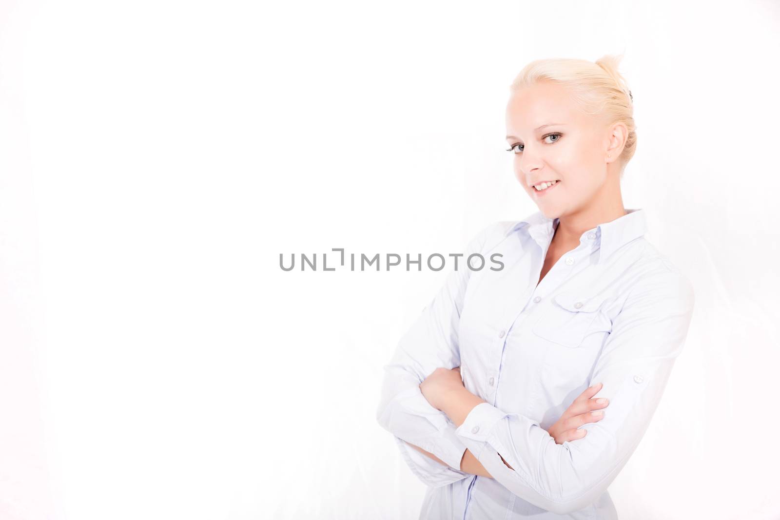 Portrait of a young blonde secretary in a white office.
