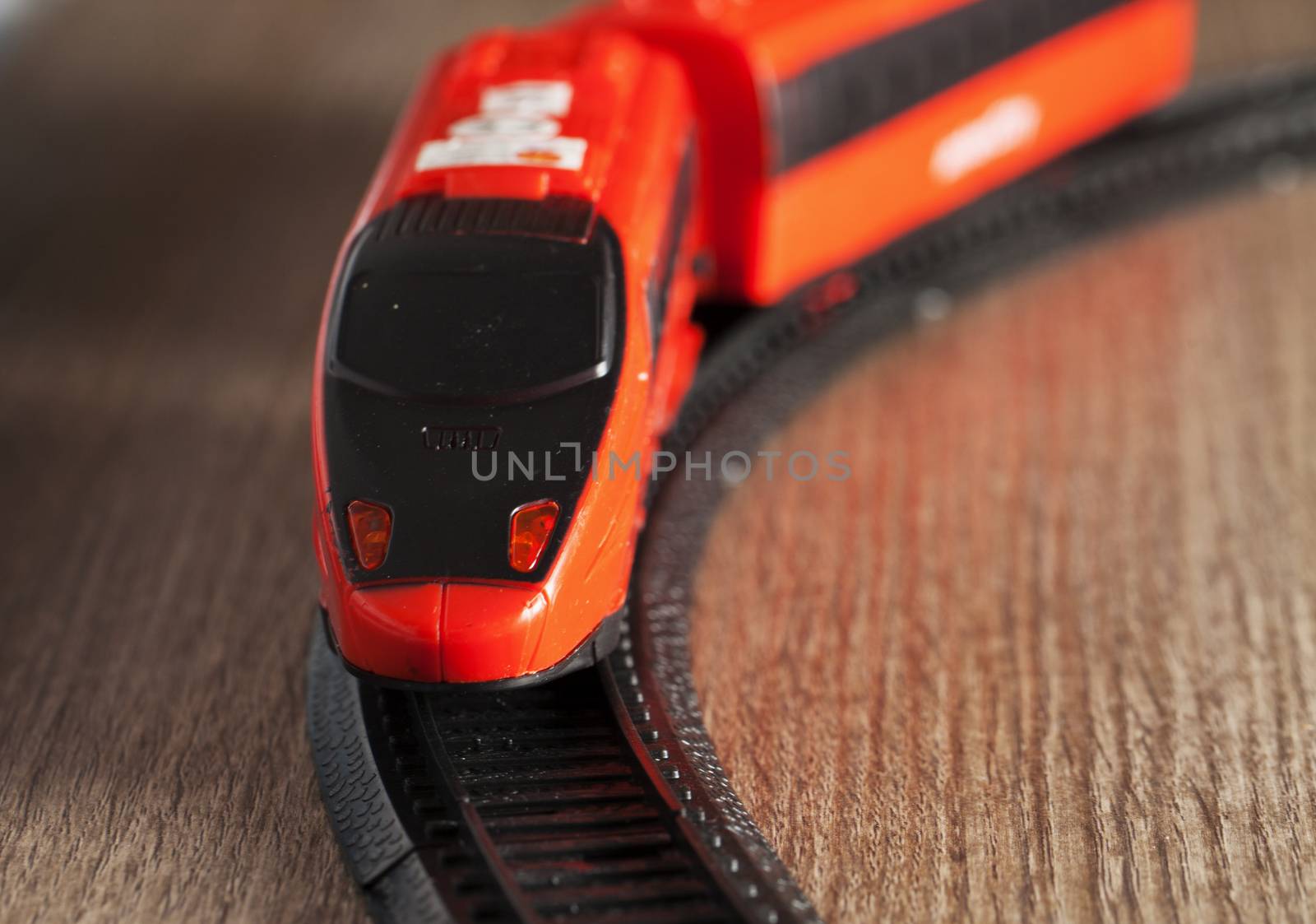 Red toy train running in strict close up 