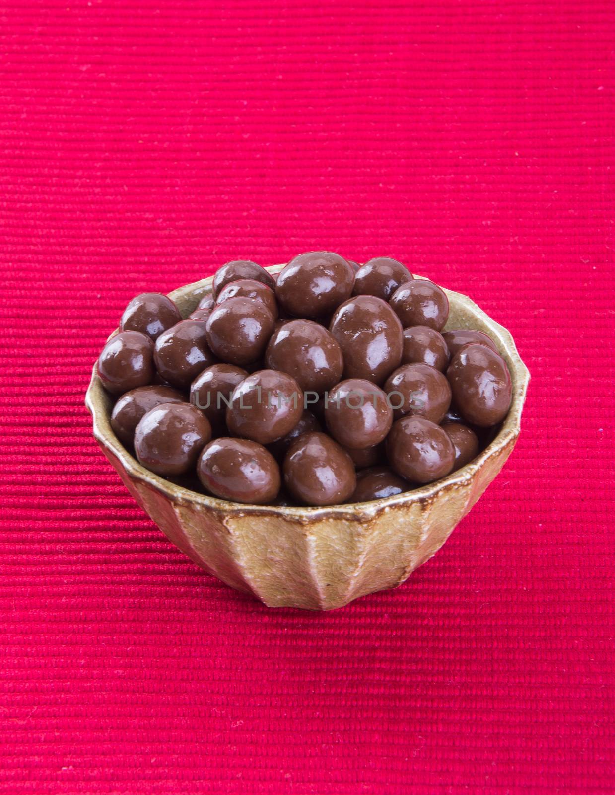 chocolate balls. chocolate balls in bowl on a background by heinteh