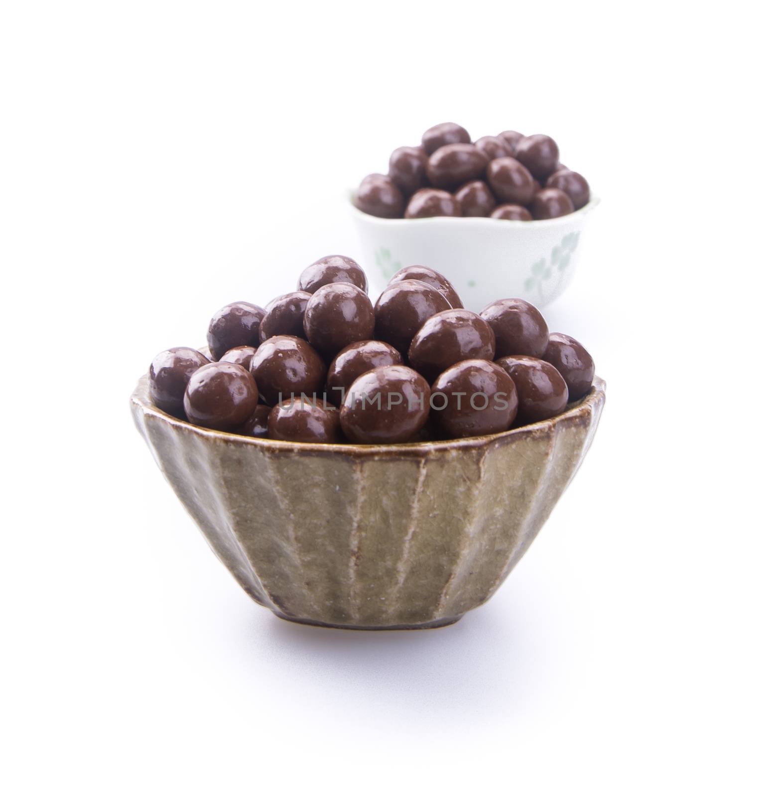 chocolate balls. chocolate balls in bowl on a background.