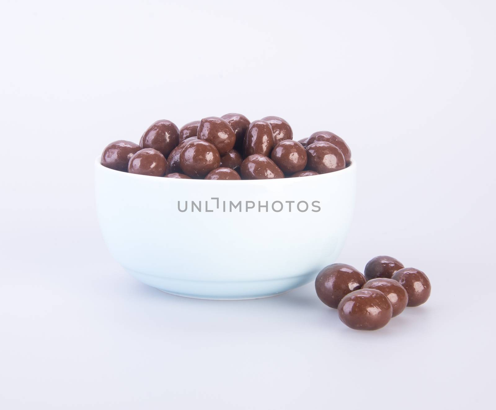 chocolate balls. chocolate balls in bowl on a background.