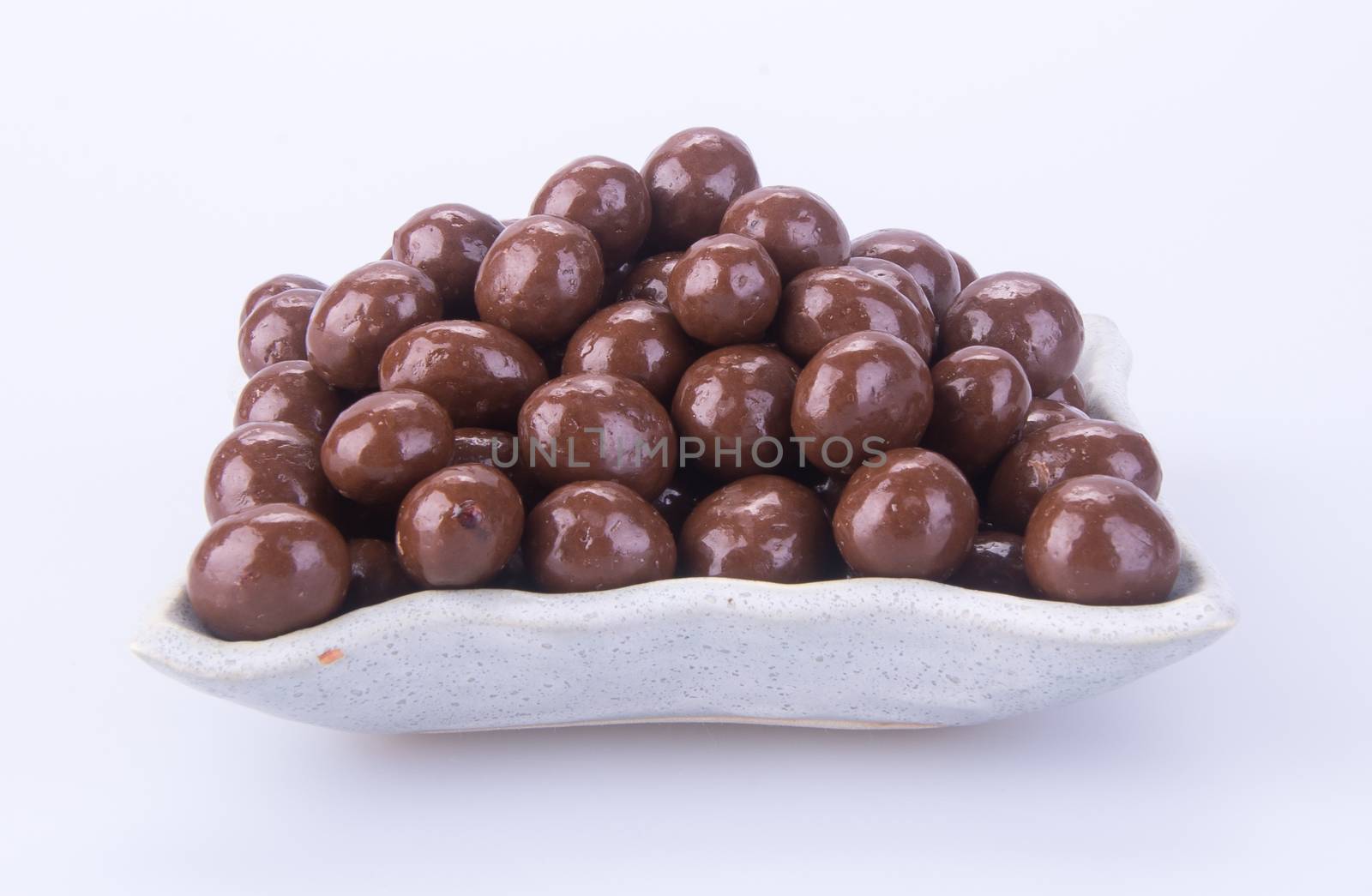 chocolate balls. chocolate balls in bowl on a background by heinteh