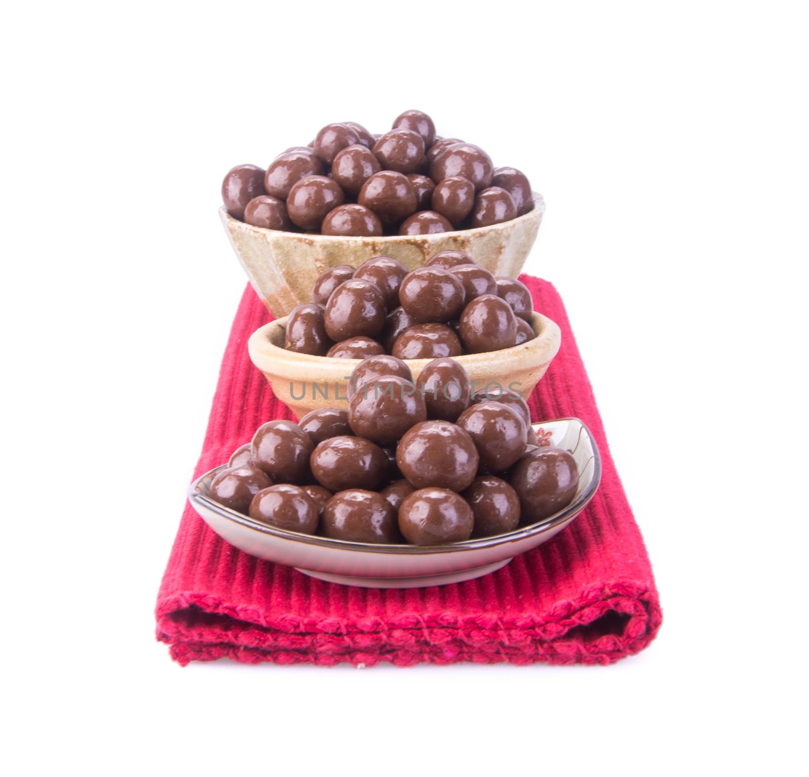 chocolate balls. chocolate balls in bowl on a background.