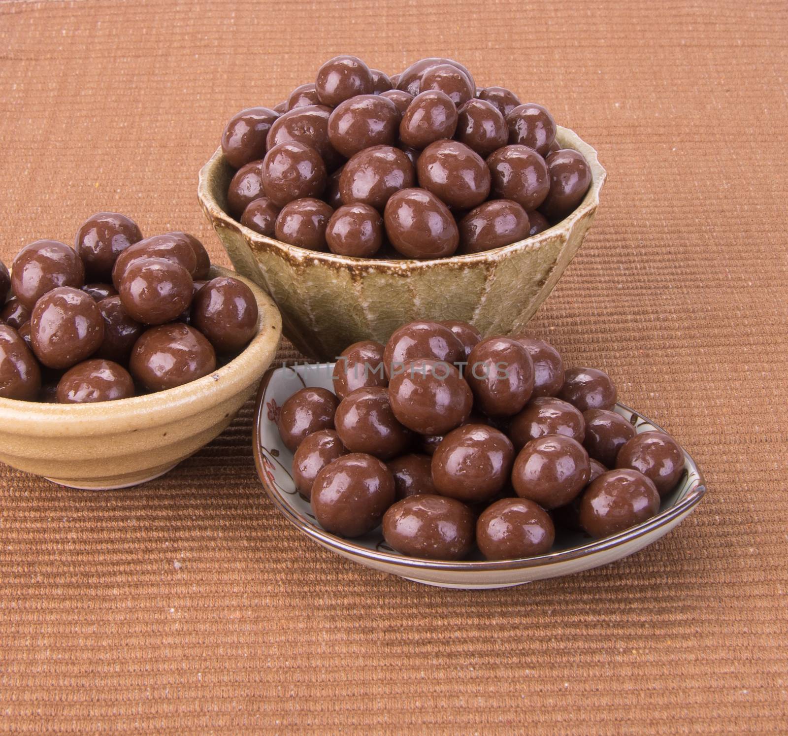 chocolate balls. chocolate balls in bowl on a background.