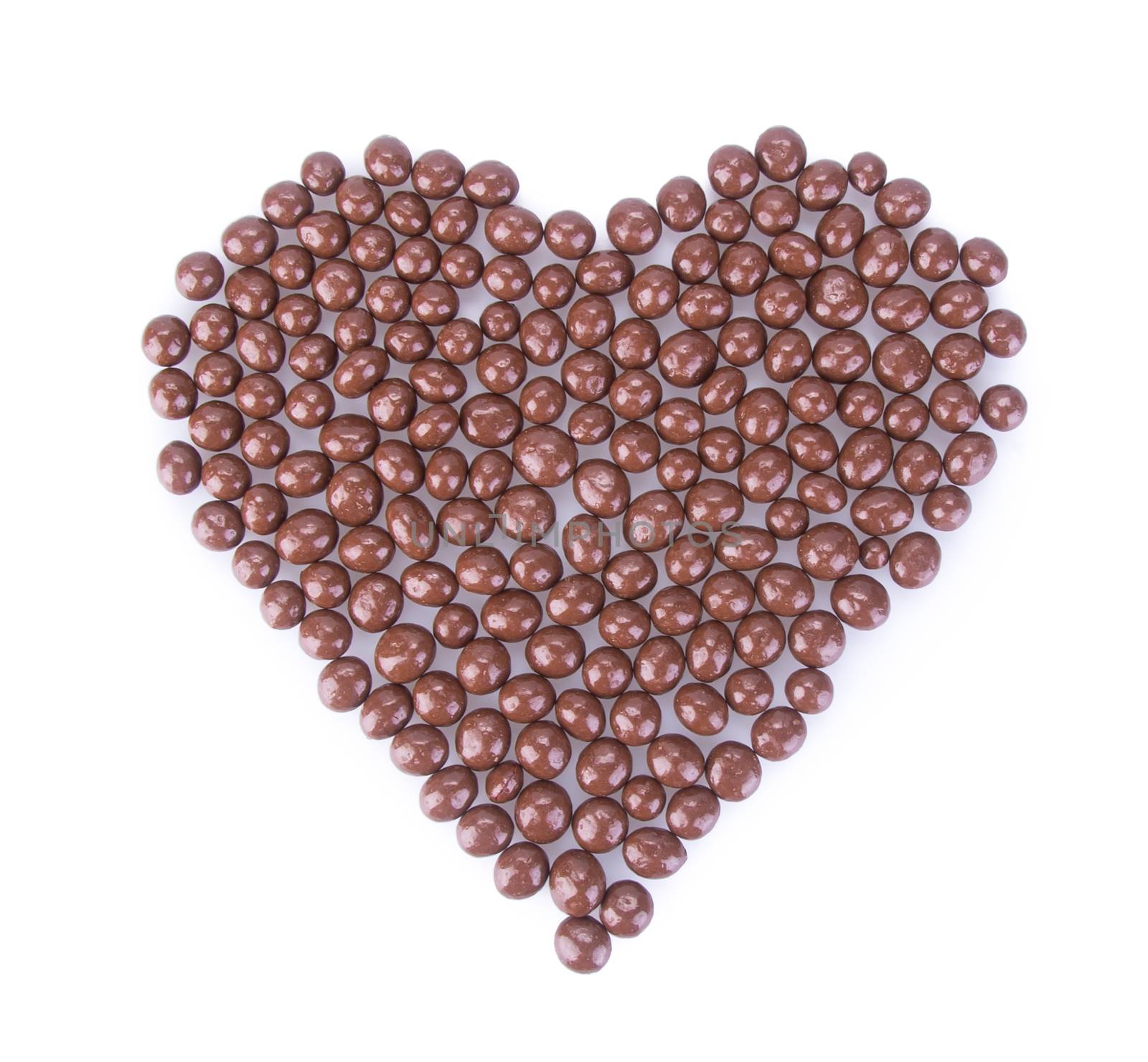 chocolate balls. chocolate balls in love shape on a background.