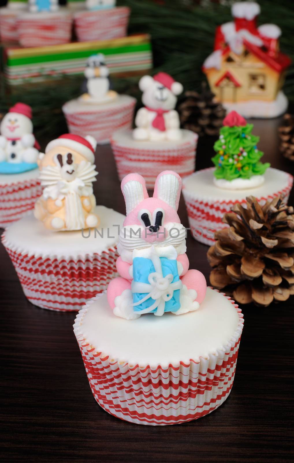Sugar Christmas figurine hare with a gift on muffin