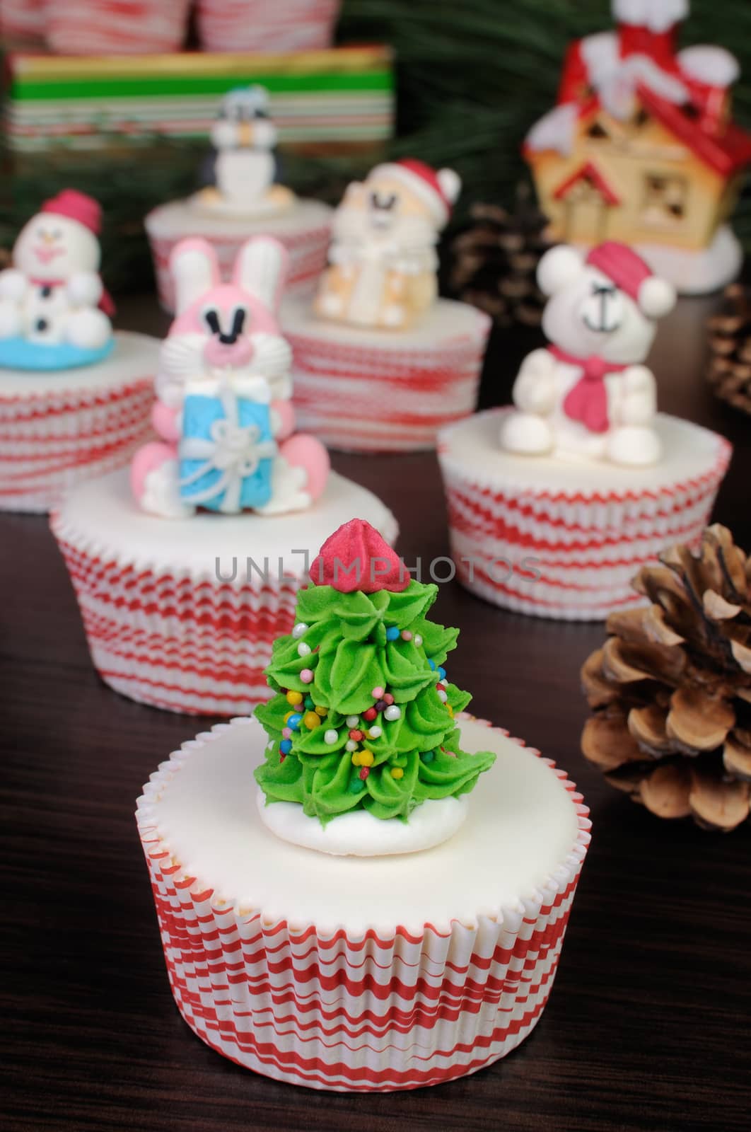 Sugar figurine Christmas tree on the glazed muffin