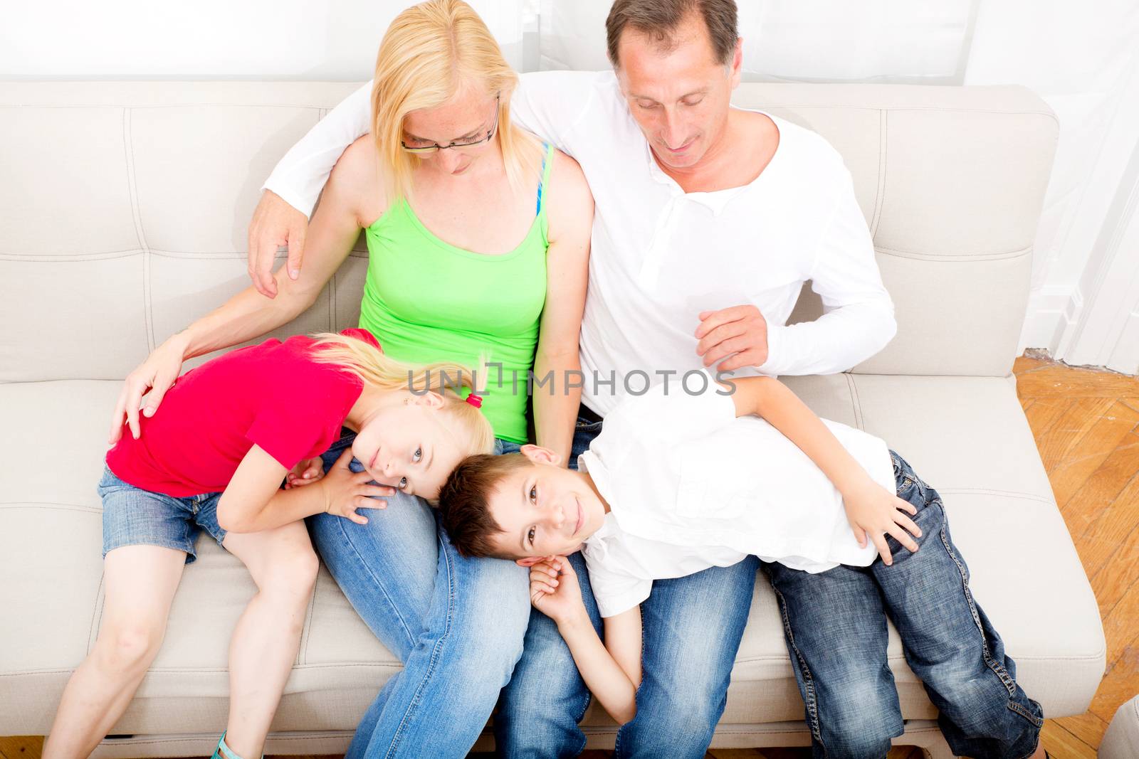 Happy family sitting together on the couch
