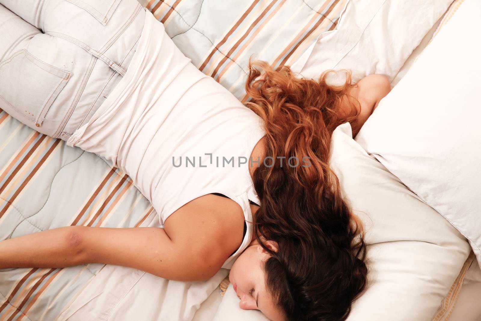 A young woman sleeping on the bed.