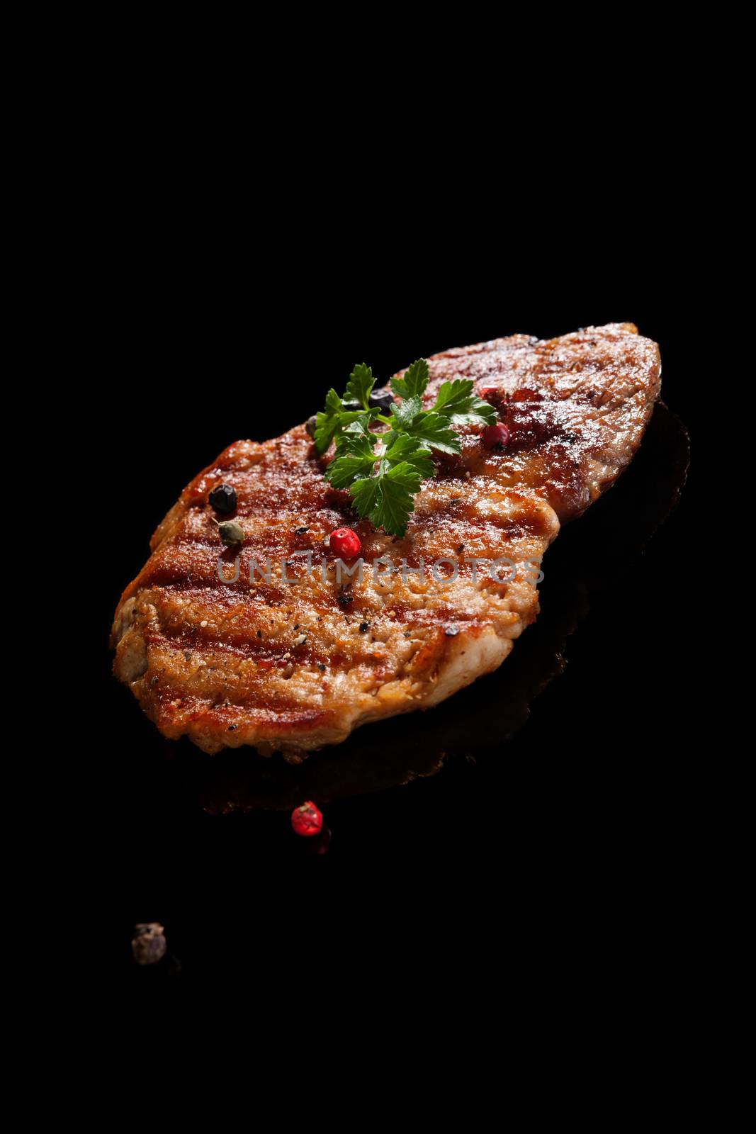 Grilled meat isolated on black background. Culinary meat eating. 