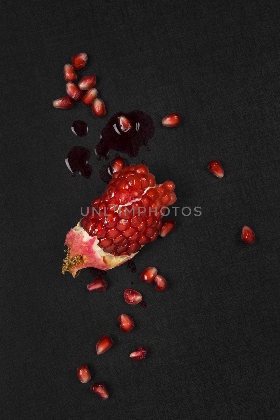 Pomegranate on black background. by eskymaks