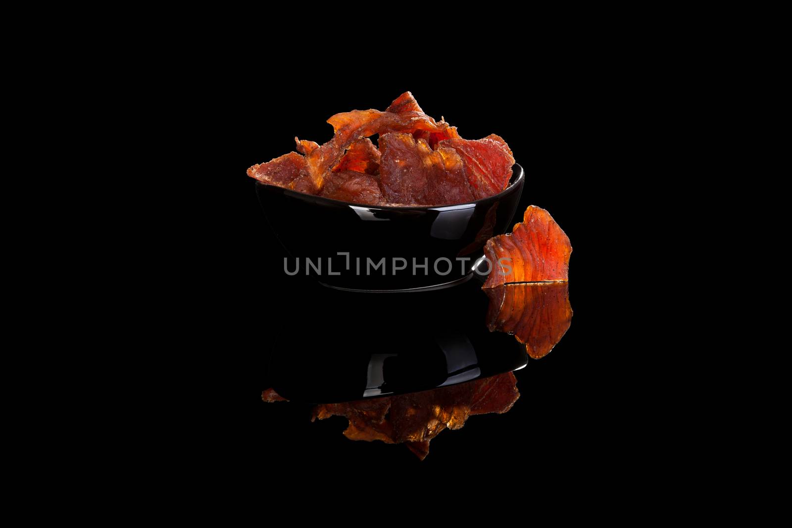 Beef jerky isolated on black. by eskymaks