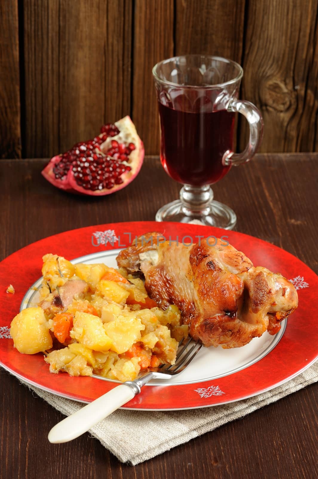 Grilled turkey with mashed potatoes, pomegranate and glass of wine on wood background