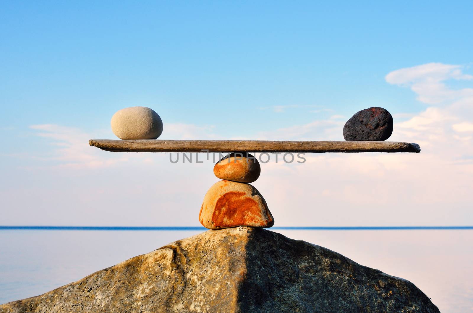 Balancing of pebbles on the top of stone