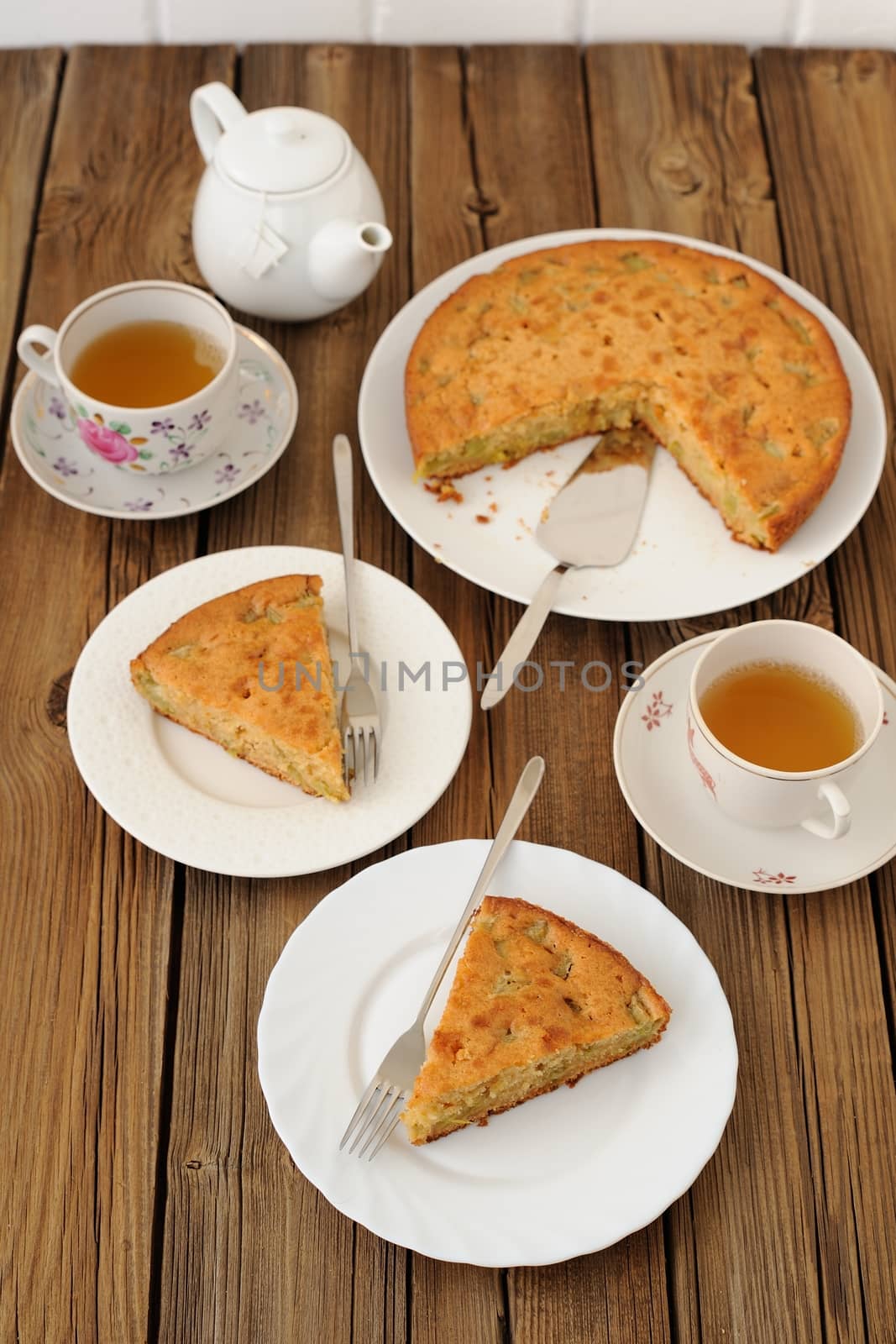 Old fashioned apple pie with black tea on wooden background by Borodin