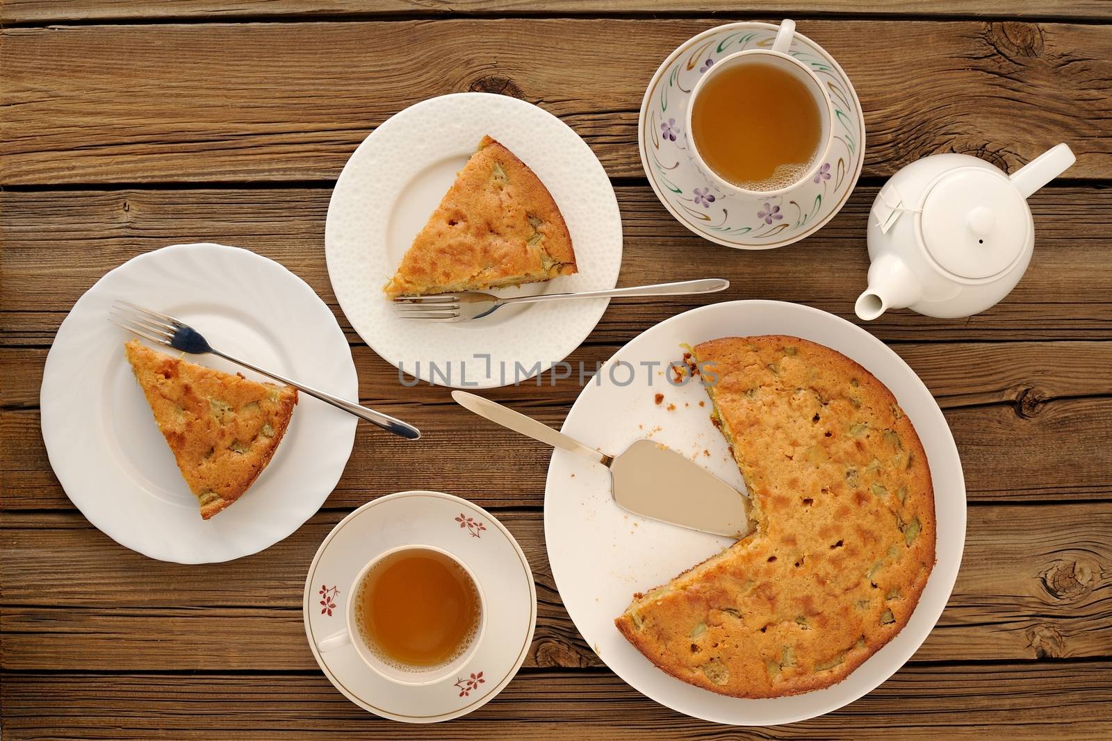 Old fashioned apple pie with black tea on wooden background by Borodin