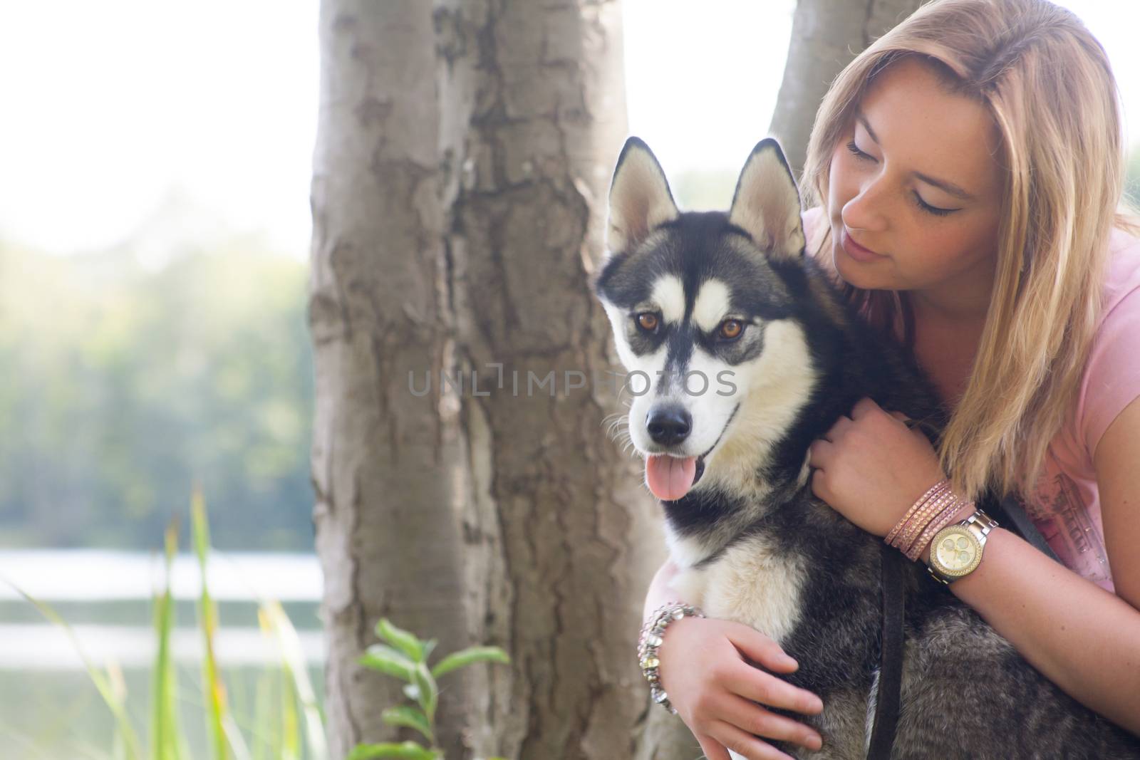 Young woman and her husky in the forest