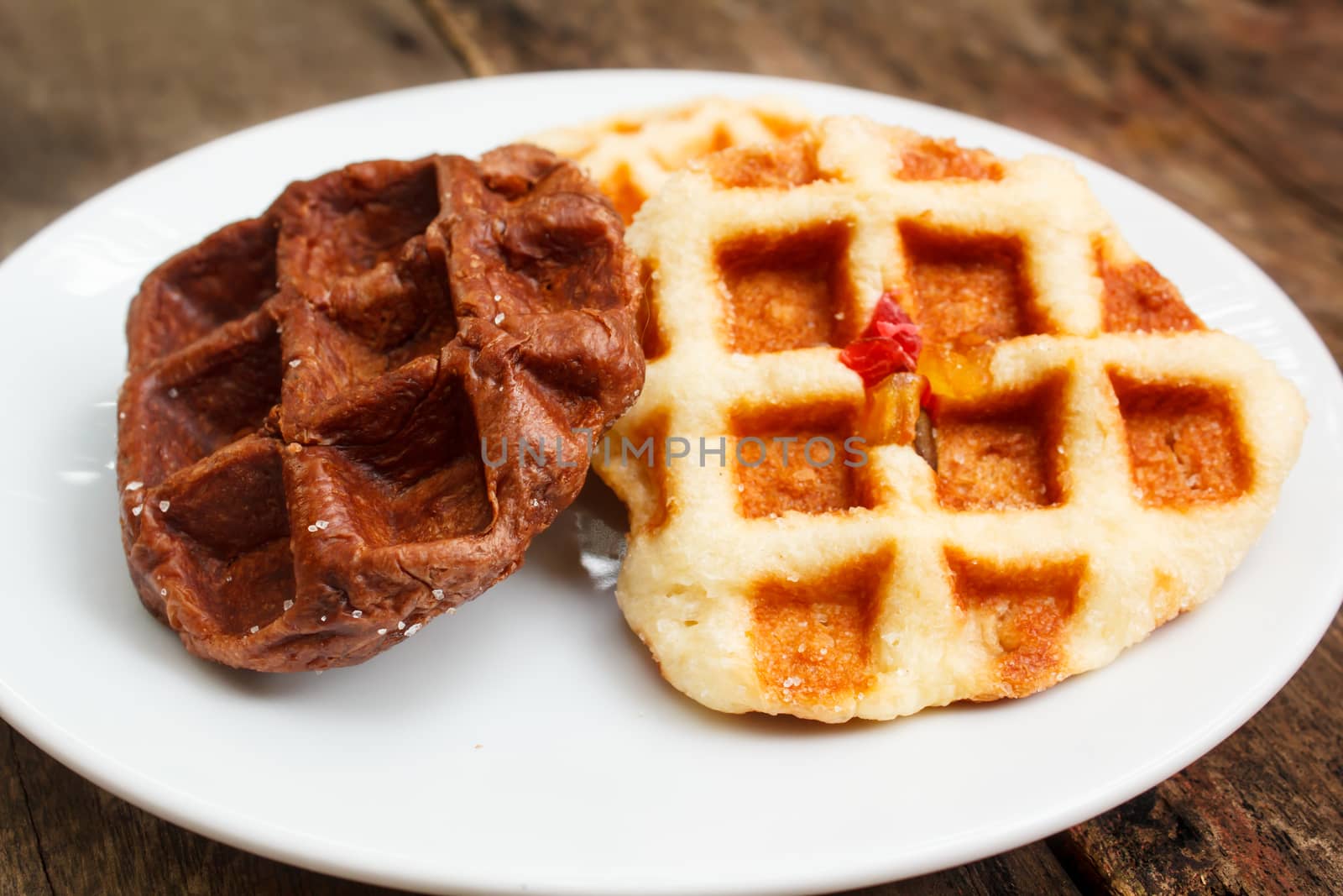 fresh waffle on white plate at restaurant.