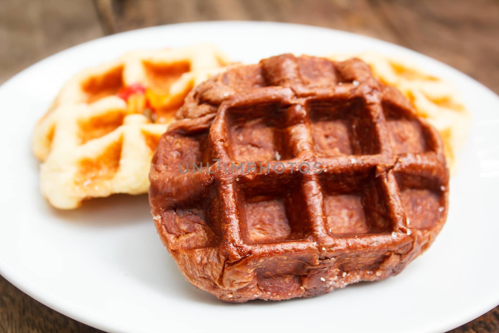 fresh waffle on white plate at restaurant.