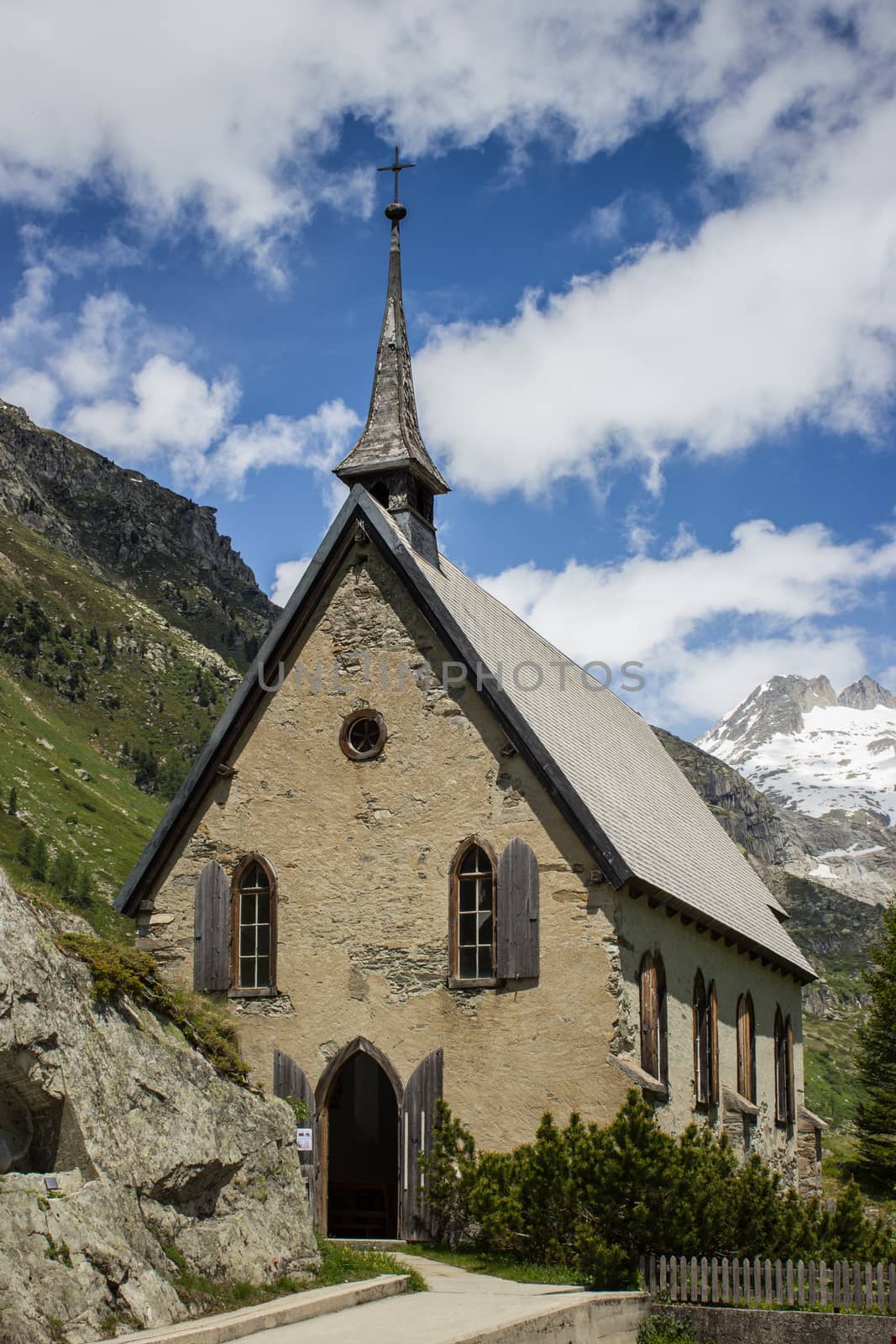Switzerland, church among alpine mountains