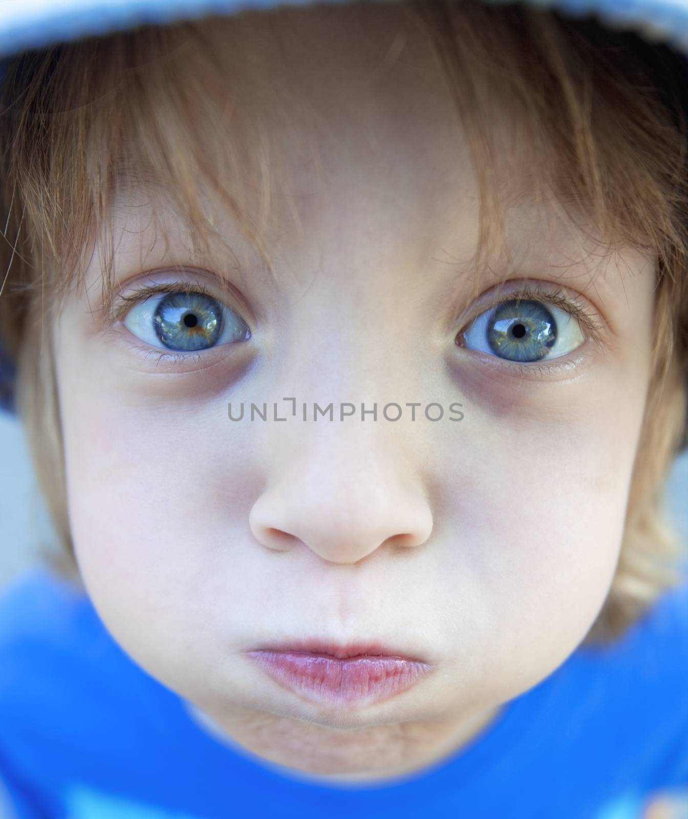 Boy with Blond Hair Making Faces by courtyardpix