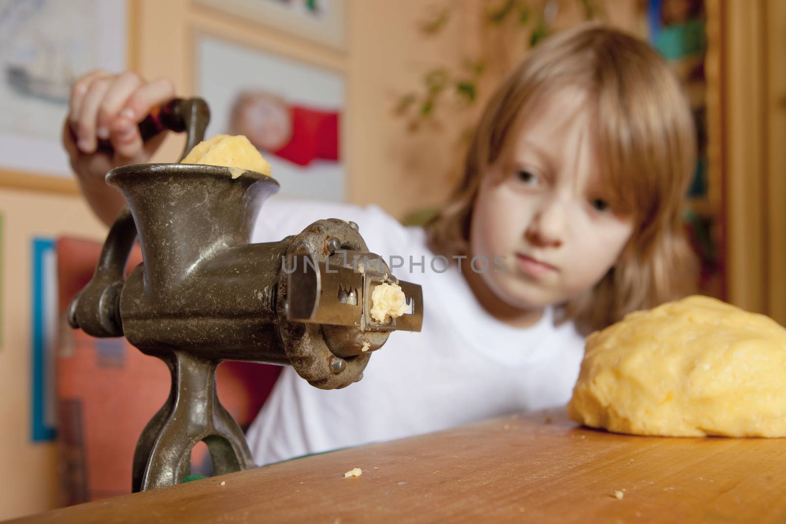 Boy Grinding Flour in the Kitchen