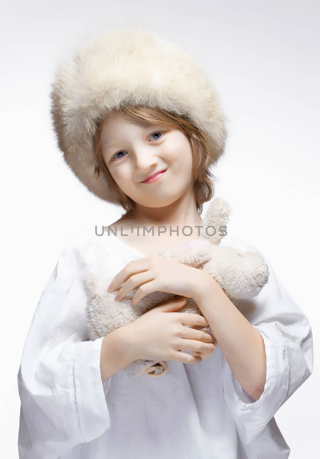 Portrait of a Boy with Fluffy Hat and Stuffed Animal by courtyardpix