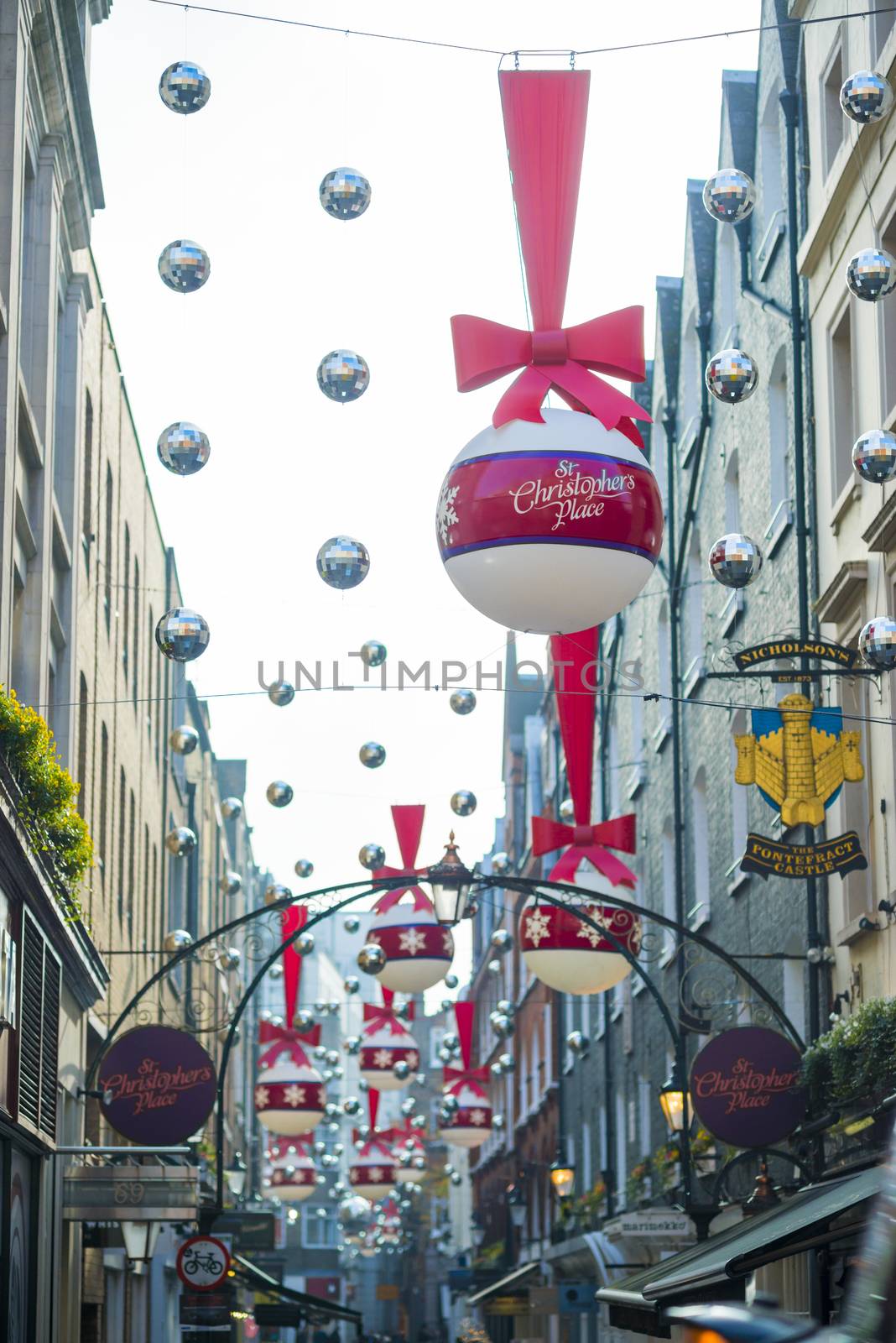 LONDON, UK - NOVEMBER 20: low angle shot of Christmas decoration in St. Christopher's Place. November 20, 2014 in London. The traditional pedestrianised street is home to high end retail units.