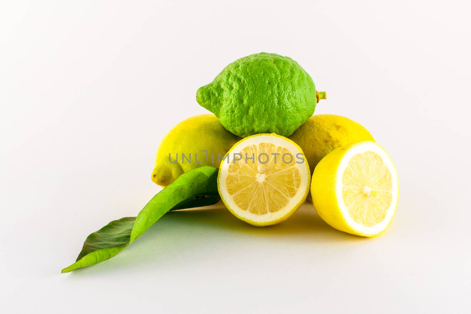 Fresh lemons yellow and green on white background