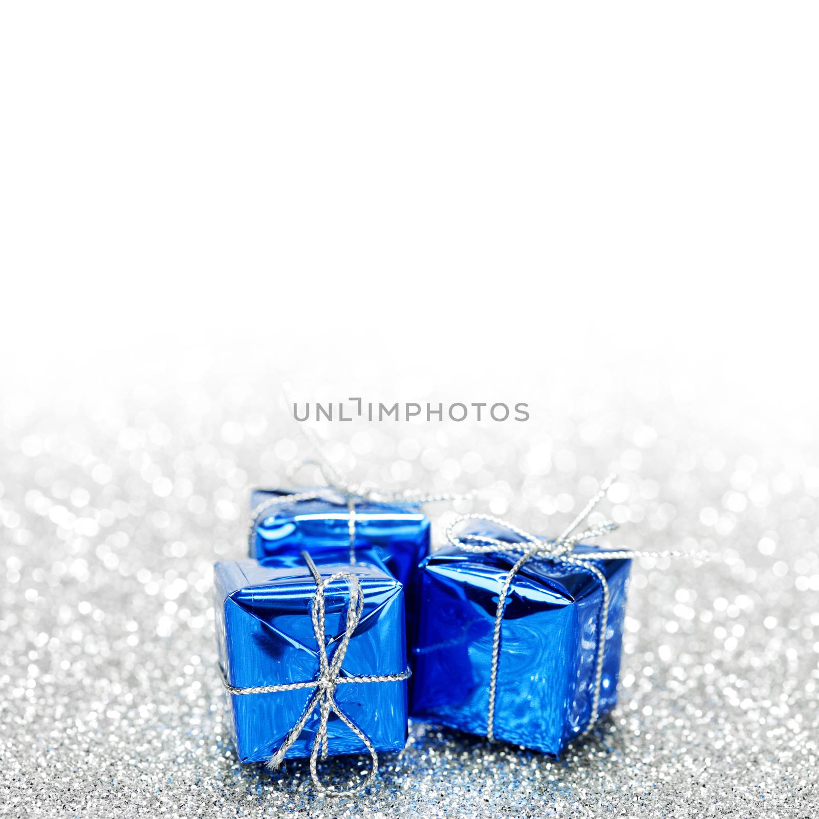 Decorative blue holiday gift boxes on bright shiny background