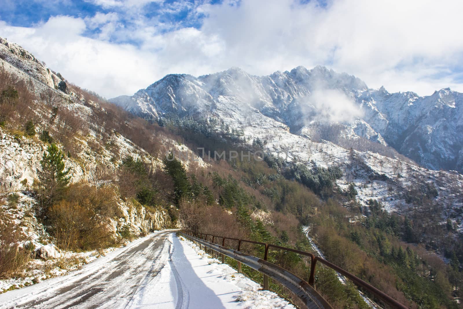 The first snow of the Apuan Alps whitening white marble quarries