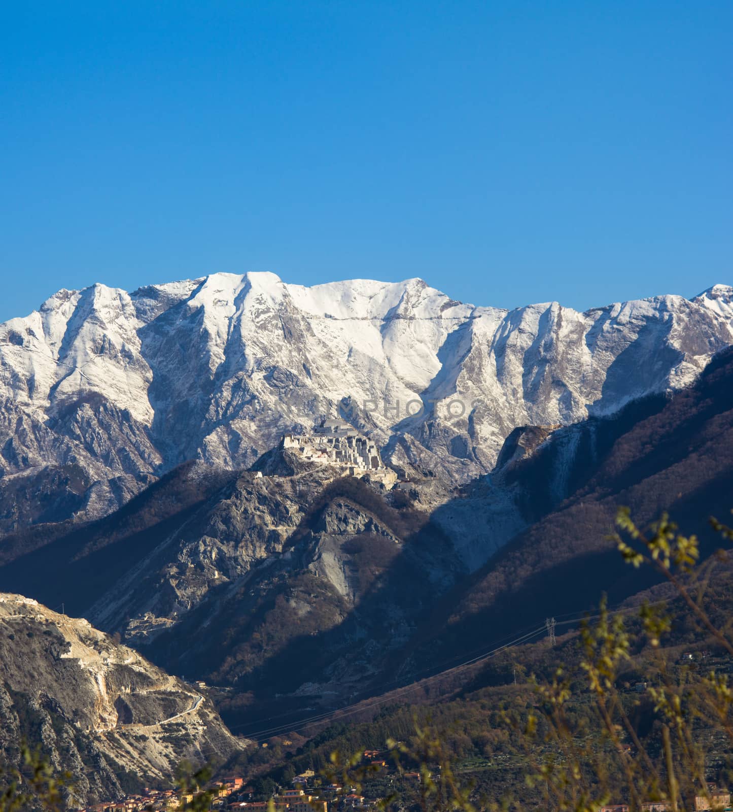 The first snow of the Apuan Alps whitening white marble quarries